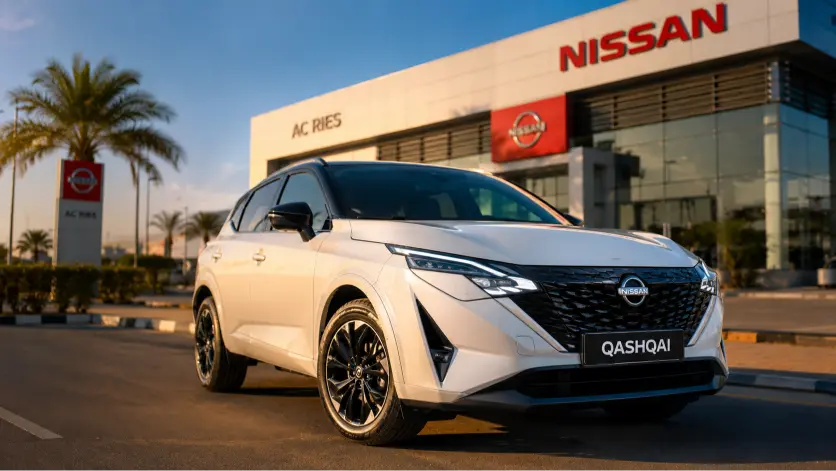 Nissan Qashqai 2026 blanc nacré devant concession officielle Nissan Djibouti ciel bleu ensoleillé